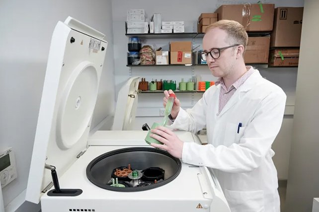 Biotechnologist Stephen Wallace harvesting engineered bacteria. (Edinburgh Innovations)