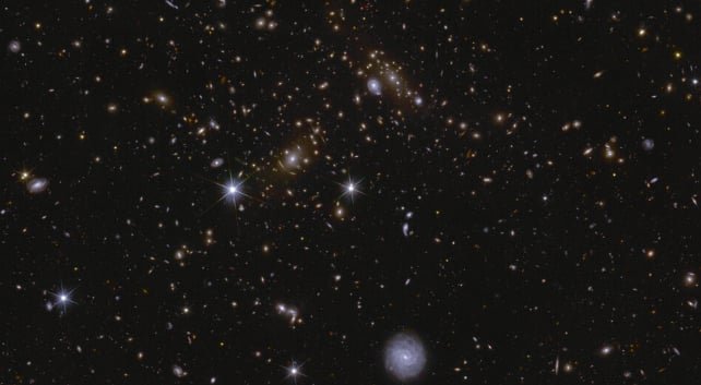 This is a zoomed-in portion of Euclid's image of its Deep Field South at 70x. It's swarming with galaxies, and Euclid has already found more than 11 million in the field. A gravitational lens is also visible in the center